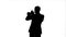 Silhouette Portrait of a young man playing his