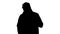Silhouette A positive bearded male dressed in a trench coat walking and talking.