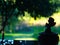 Silhouette of a praying angel against the background of an august evening