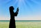 Silhouette of praying woman