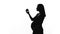 Silhouette of pregnant woman eating apple, healthy diet during childbearing