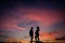 Silhouette pregnant woman with her partner and sunset