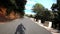 Silhouette of professional cyclist descending down beautiful mountain curvy road