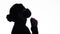 Silhouette profile of young woman thinking in protective mask on white studio background, figure of pensive girl, concept health