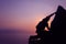 Silhouette purple of man climbing rock, Photographer on the mountain at sunrise