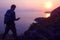 Silhouette purple of man climbing rock, Photographer on the mountain at sunrise