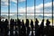 Silhouette queue people waiting in line for airplane in terminal with mountain background