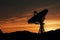 The silhouette of a radio telescope observatory