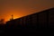 Silhouette of Railway Auto Cars Against Golden Sunset