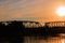 Silhouette railway bridge and reflex in river before sunrise in the morning with copy space add text