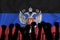 Silhouette of raised arms and clenched fists on the background of the flag of Donetsk People`s Republic. The concept of power,