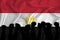 Silhouette of raised arms and clenched fists on the background of the flag of Egypt. The concept of power, power, conflict. With