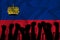 Silhouette of raised arms and clenched fists on the background of the flag of Liechtenstein. The concept of power,  conflict. With