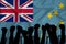 Silhouette of raised arms and clenched fists on the background of the flag of Tuvalu. The concept of power,  conflict. With place