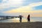 Silhouette rear view of young woman standing on the beach near the sea and sky Twilight background for amazing landscape