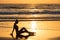 Silhouette of a relax girl on the beach at sunset. Woman on background of the ocean