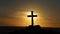 Silhouette of a religious Cross Crucifix against a sunset