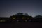 Silhouette of a residential building in the desert in the light of the moon