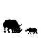 Silhouette of rhino and young small rhino