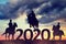 Silhouette of a riders riding a horse in the sunset. New Year 2020 concept.