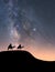 Silhouette of riders on their camels in the desert at night