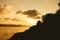 Silhouette of romance couple sitting on a rock