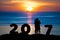 Silhouette of romantic a couple hug kissing against summer sea in sunset twilight sky while celebrating happy new year 2017