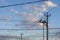 Silhouette rural electric lines with transformer vault. Top of electricity post with a lot of wire