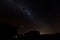 Silhouette of rural house under starry fairy night sky