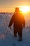 Silhouette russian man with bottle of vodka at winter sunset