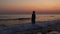 Silhouette of sad, depressed man on beach during sunset