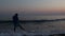 Silhouette of sad depressed man on beach during sunset
