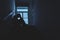 Silhouette Sad young man sitting at the stairs in the dark, Depression and anxiety disorder concept, Life problems, illness,