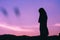 Silhouette of sadness woman standing against sunset