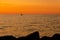 A silhouette of sailing boat on the sea during dusk.