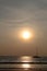 Silhouette of a sailingboat at sunset on the seashore