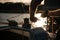 Silhouette of a sailors hands on a winch rope on a sailboat on a sunset. Shot with a selective focus.