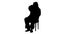 Silhouette Santa Claus sitting on chair with letters in hands