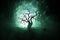 Silhouette of scary Halloween tree on dark foggy toned background with moon on back side.