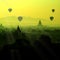 The silhouette scenic sunrise with silhouette balloons above ruin pagoda in Bagan, Myanmar.