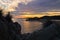 Silhouette of sea rocks and reflection of cloudscape at sunset