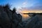 Silhouette of sea rocks and reflection of cloudscape at sunset