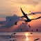 Silhouette seagulls flying over sea