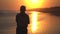 Silhouette of senior man walking on beach