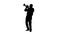 Silhouette Senior musician playing a trumpet.