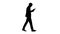 Silhouette Serious businessman using phone voice dial while walking.