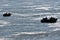 Silhouette of several fishermen fishing in rough waters