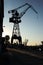 Silhouette of shipyard`s tall crane.