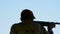 Silhouette of a shooter skeet aiming and shooting in championship