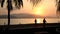 Silhouette shot of the beach with sunrise sun.